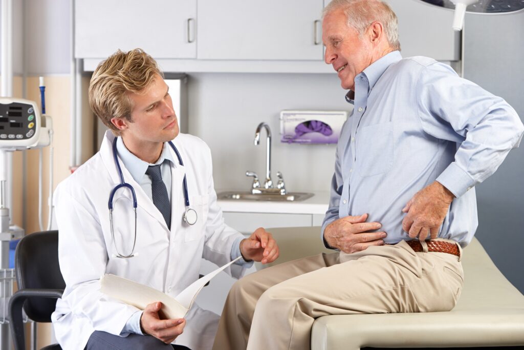 Doctor Examining Male Patient With Hip Pain | Hudson Premier PT & Sports in Union City, Jersey City, NJ