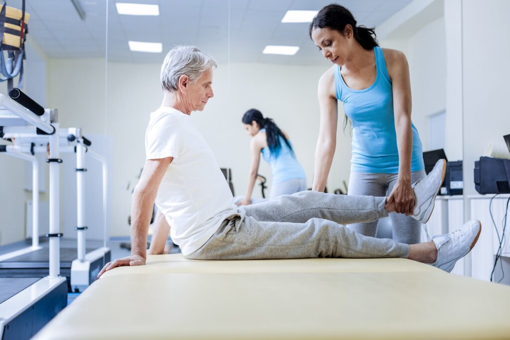Physio Therapist Treating Aged Man's Pain | Hudson Premier PT & Sports | Jersey City | Union City | NJ